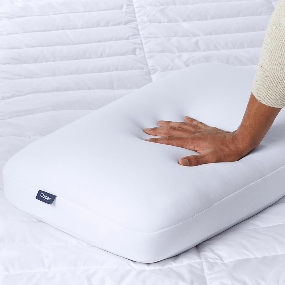 Hand Pressing Down On Casper Foam Pillow