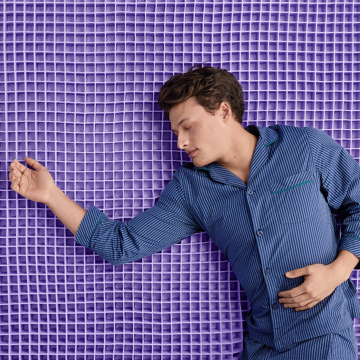 Man Sleeping On Purple Mattress Foam Grid