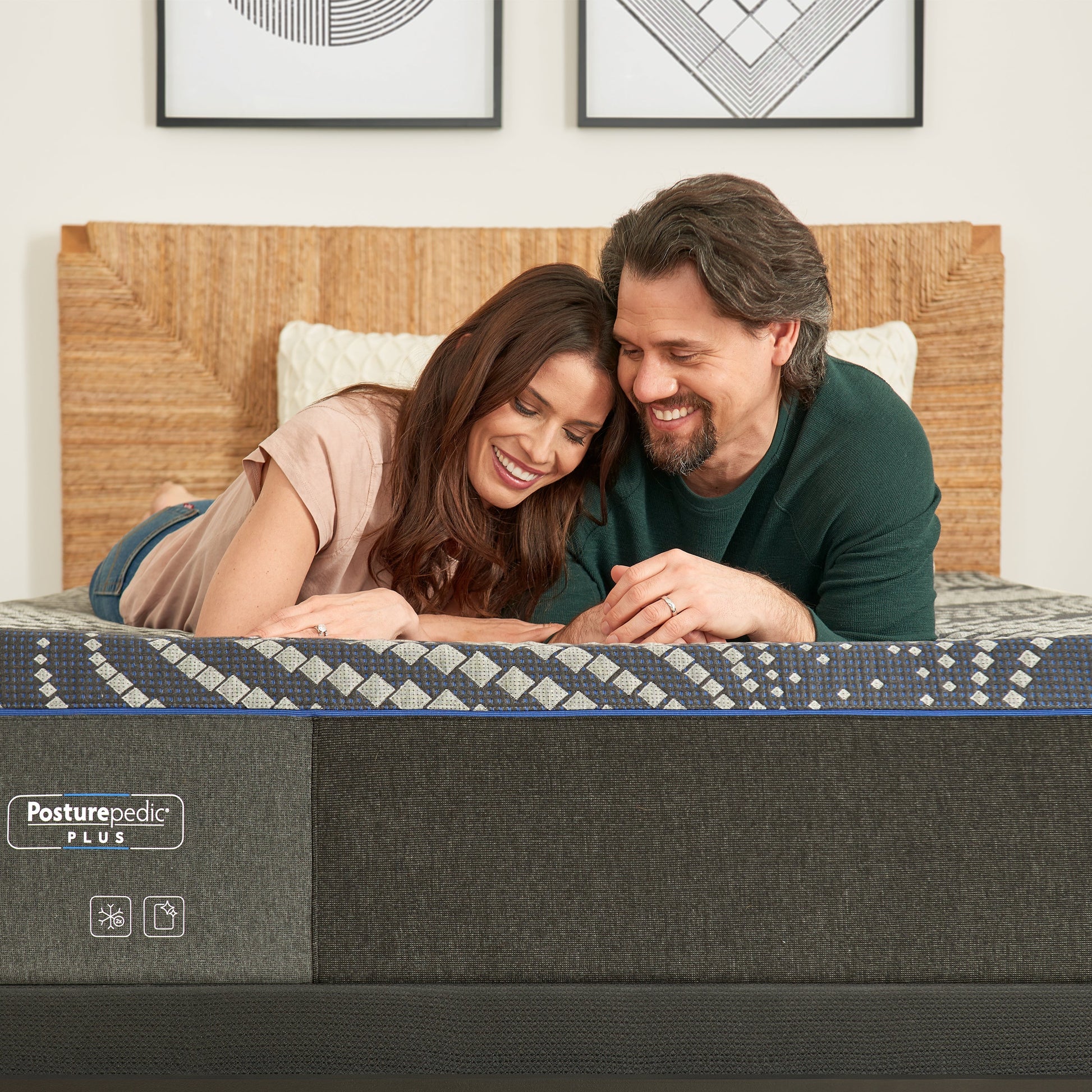 Couple Relaxing On A Sealy Albany Firm Mattress In Bedroom