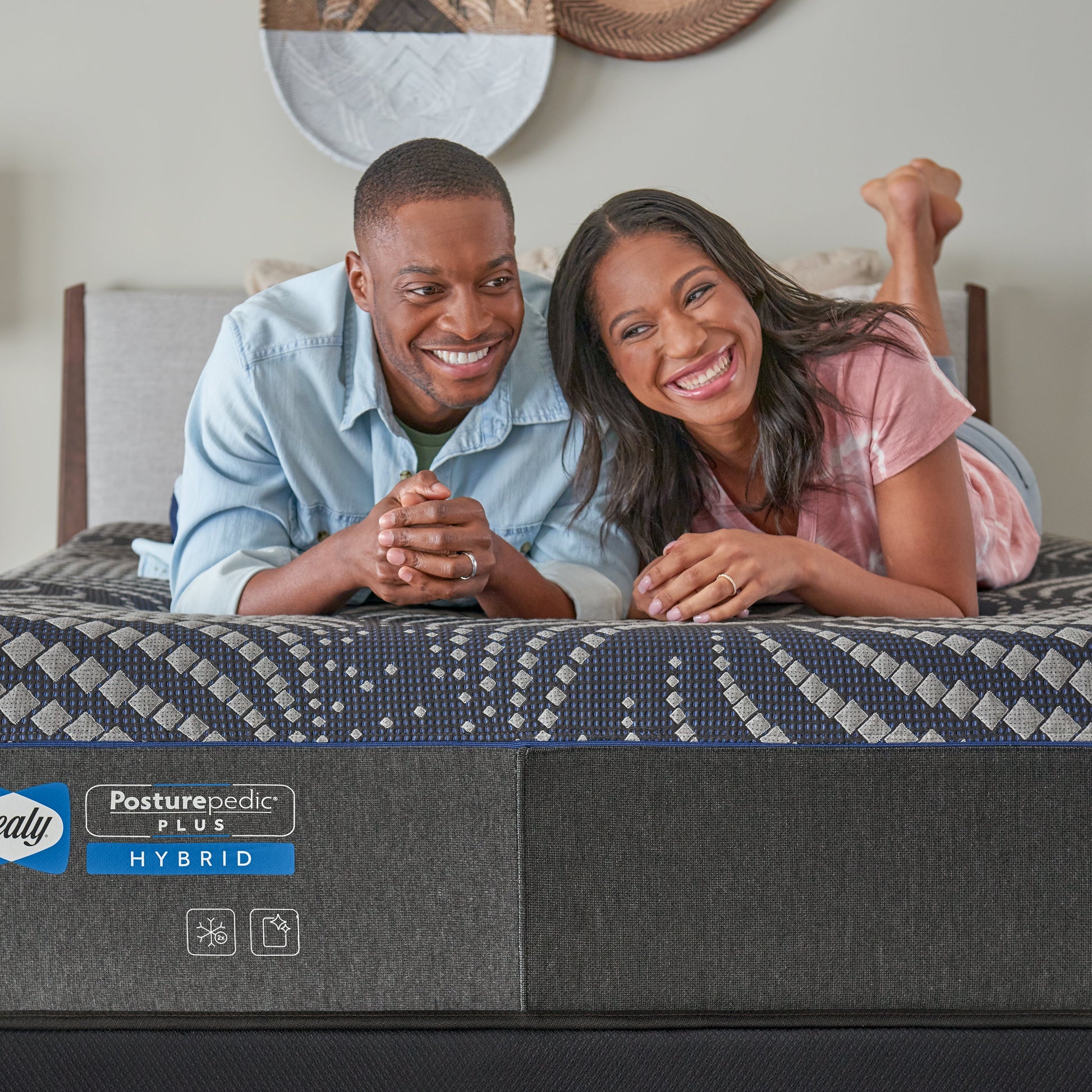 Couple Relaxing On A Sealy Albany Medium Hybrid Mattress In Bedroom