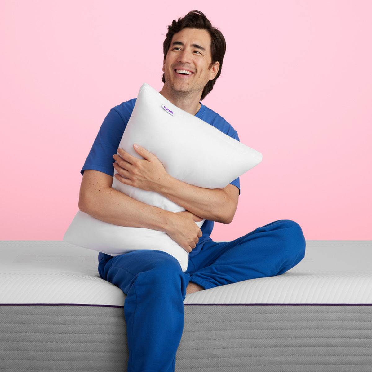 Man Holding A Purple Cloud Pillow