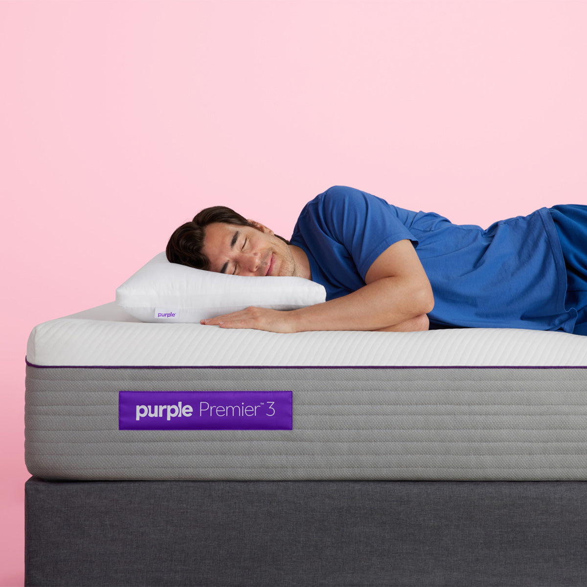 Man Sleeping On A Purple Premier 3 Mattress With A Purple Cloud Pillow