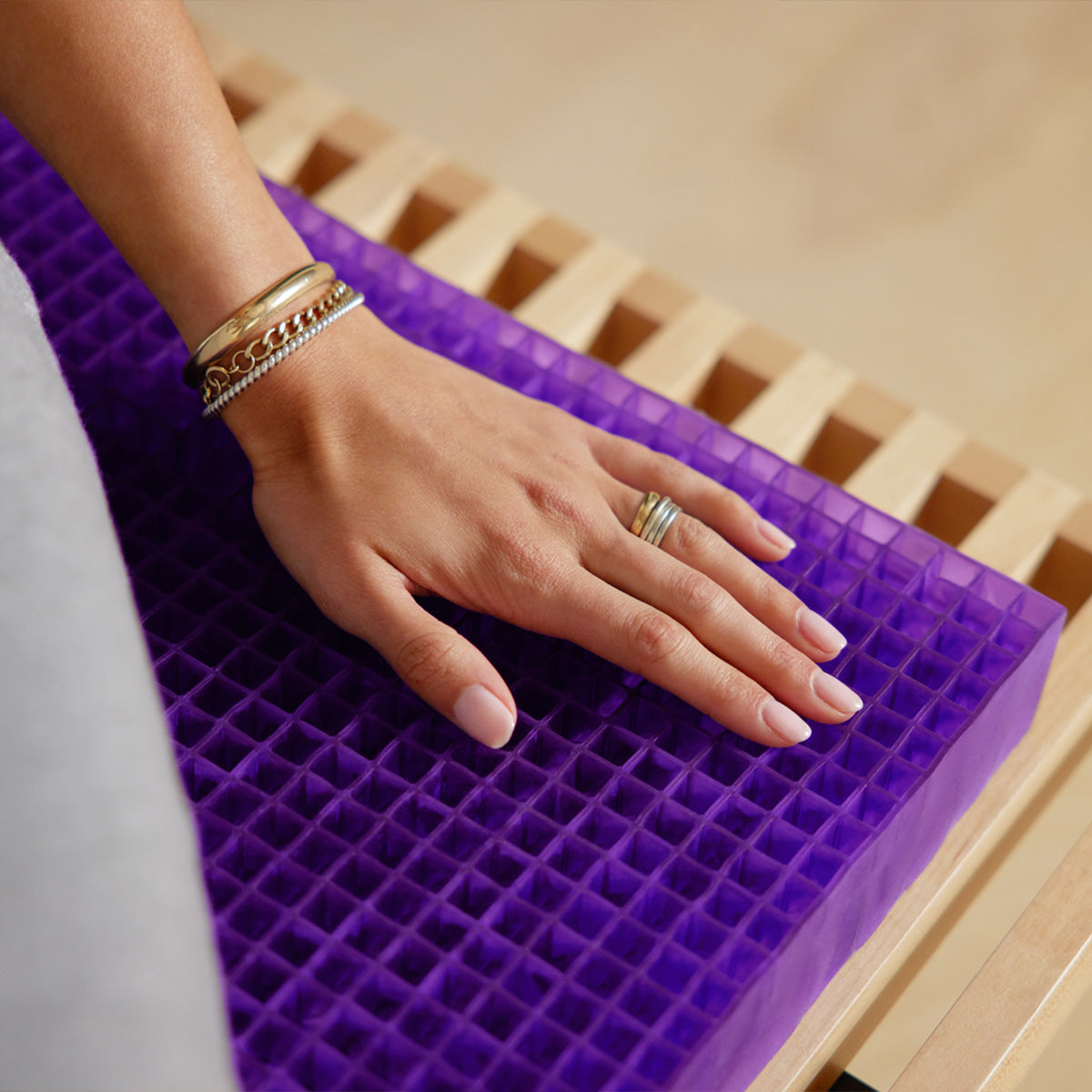 Hand Touching The Purple Grid Used In The Purple Double Seat Cushion