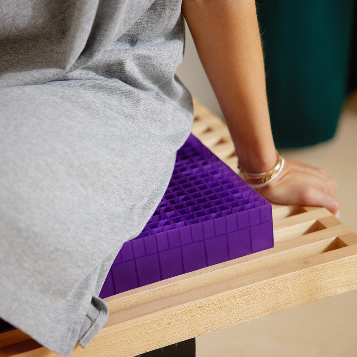Woman Sitting On The Purple Grid Used In The Purple Double Seat Cushion