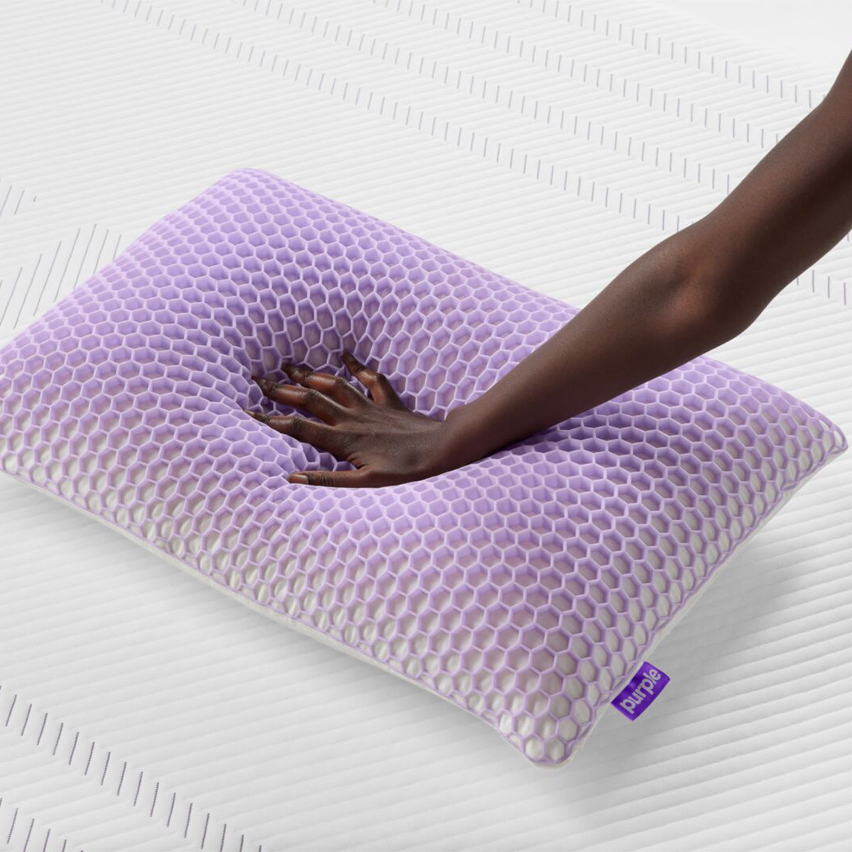 Hand Pressing Into Purple Harmony Pillow Uncovered To Show The GelFlex Grid