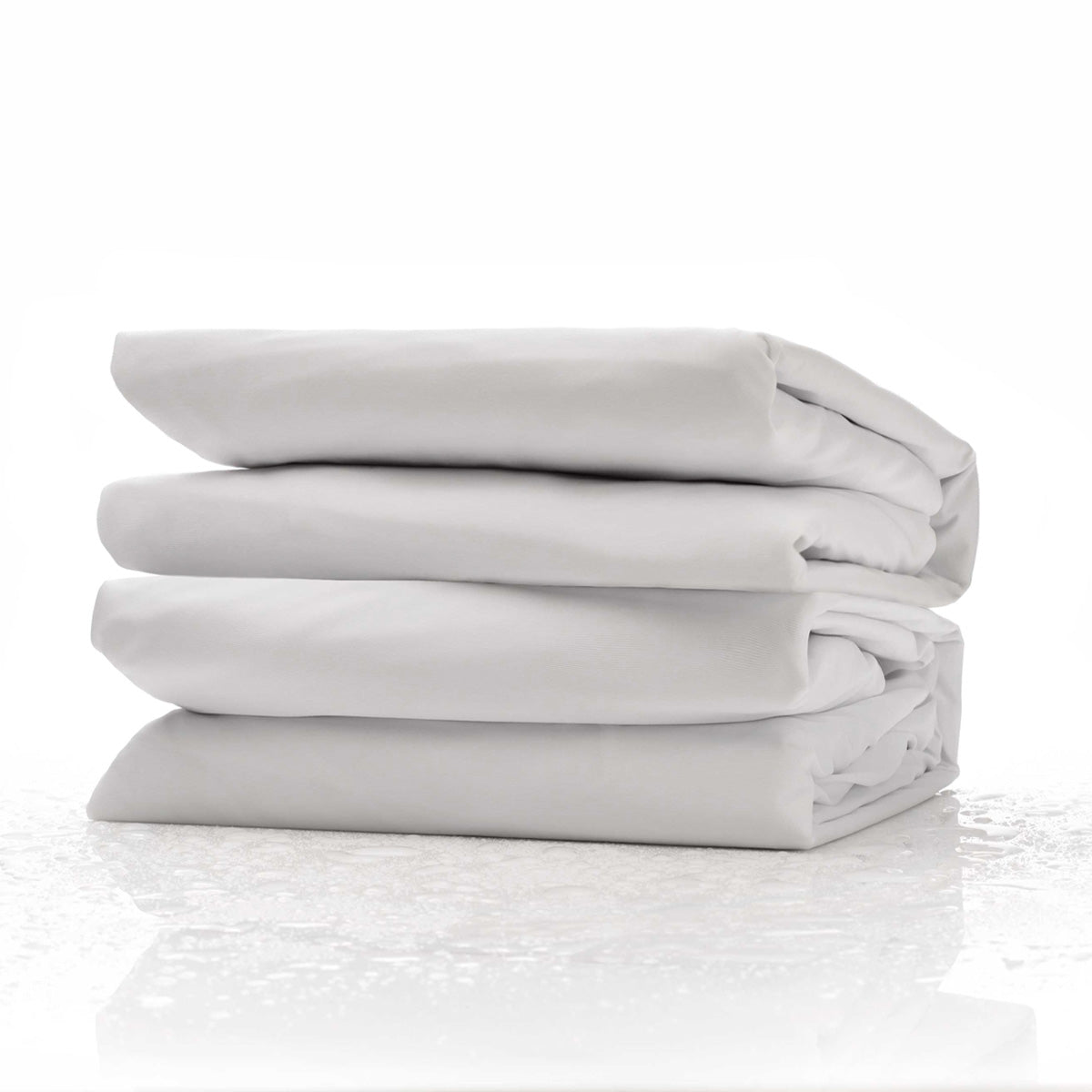 Purple Deep Pocket Mattress Protector Sitting On A Clean Surface With Water Drops Surrounding