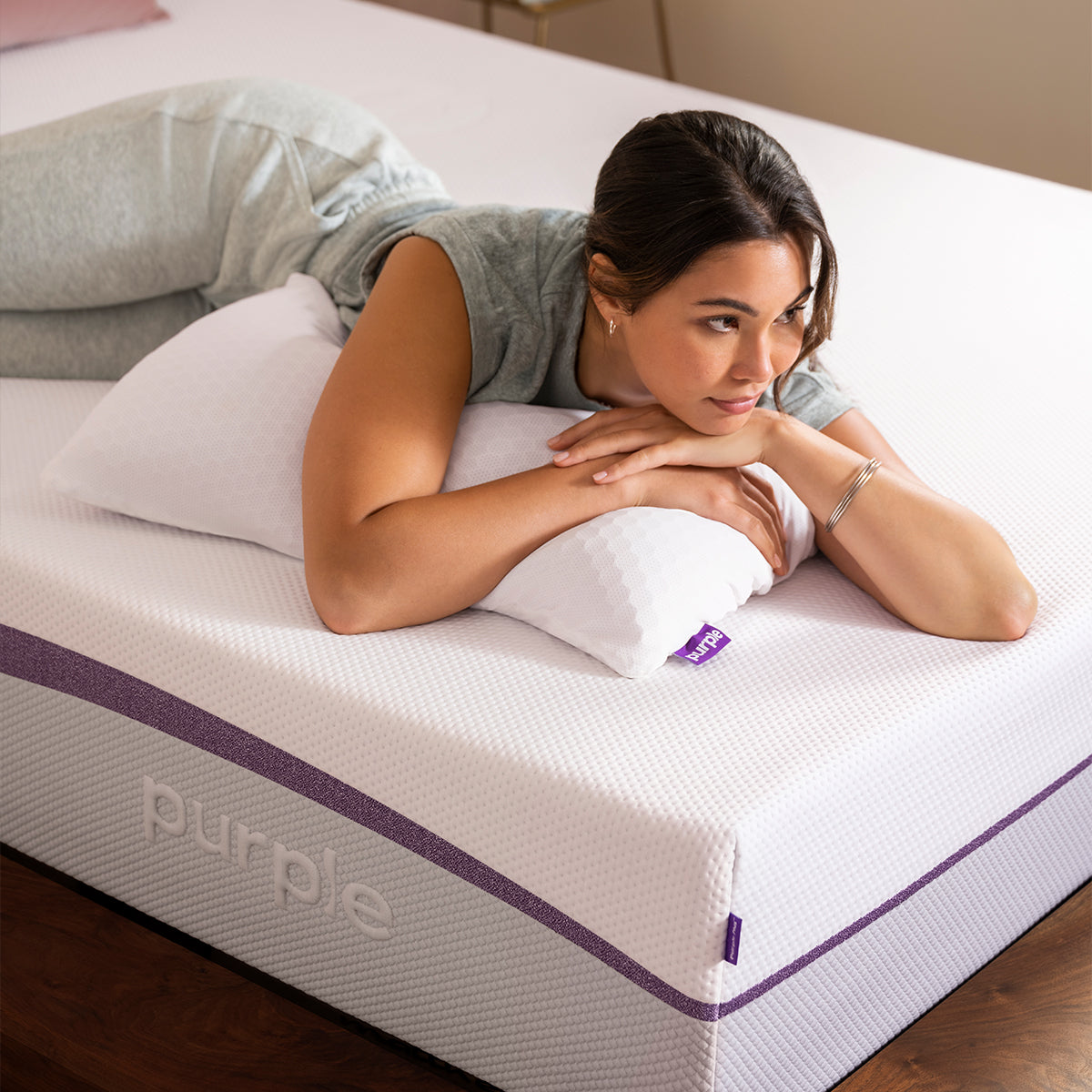 Purple Plus Mattress With Model And Pillow On Bed