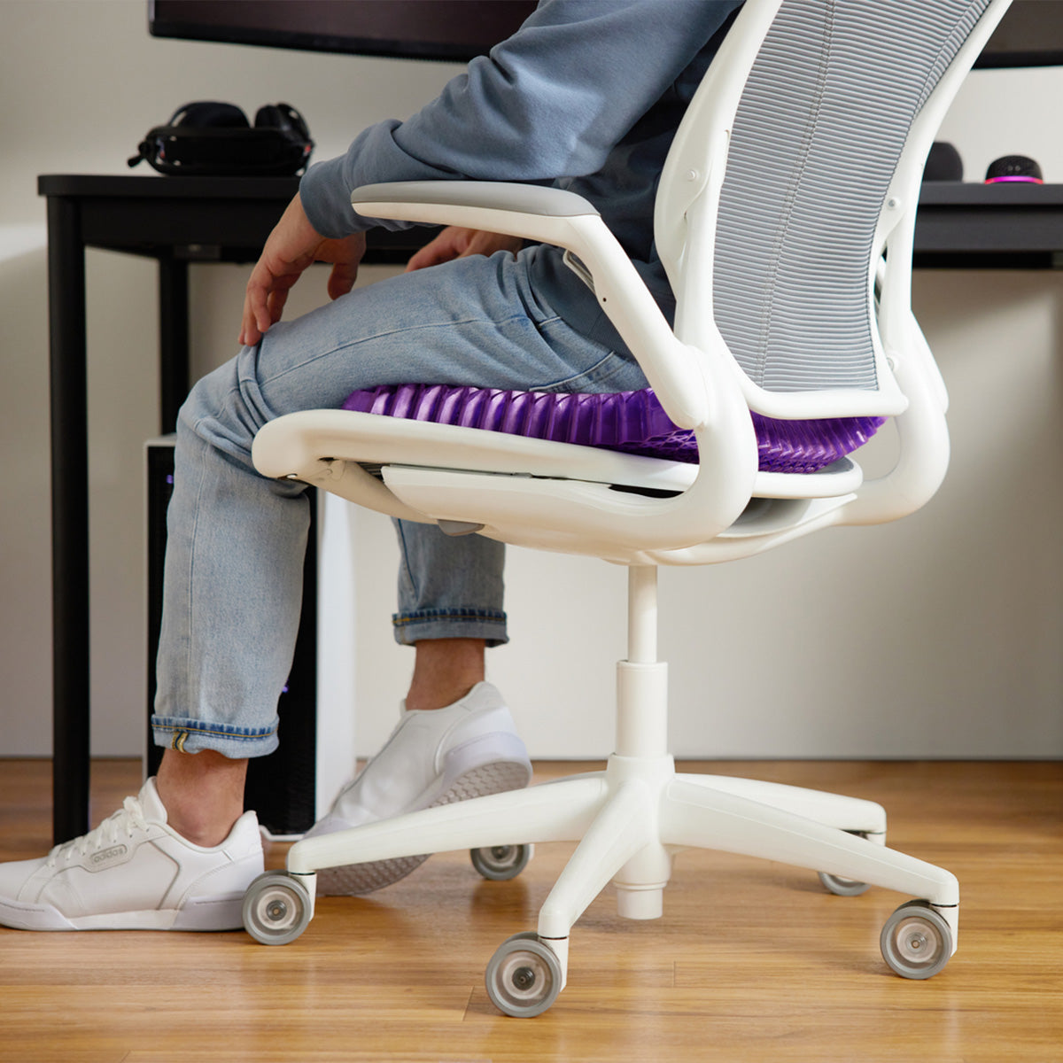 Person Sitting On Purple Royal Seat Cushion GelFlex Grid On An Office Chair At Their Desk