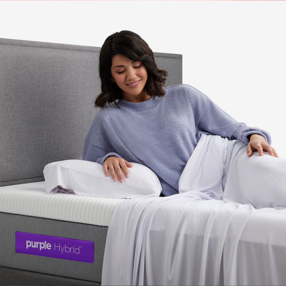 Woman Laying On Purple Hybrid Mattress And Pillow Covered With Purple SoftStretch Sheets