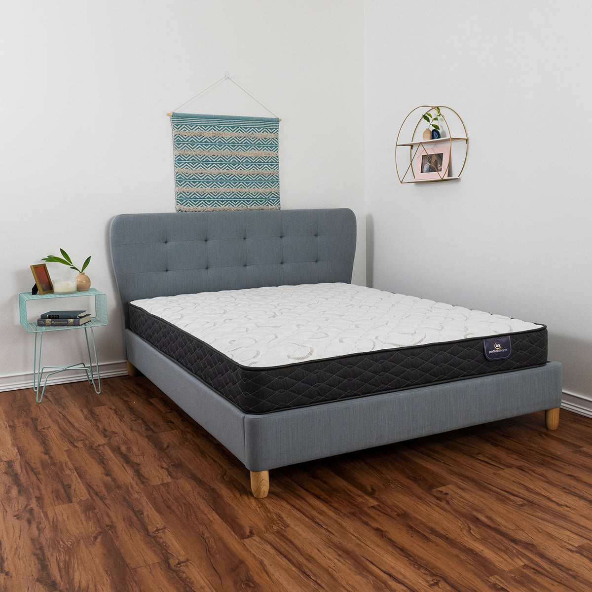 Serta Perfect Sleeper® Reedley Firm Mattress On Bed Frame In Bedroom Side View