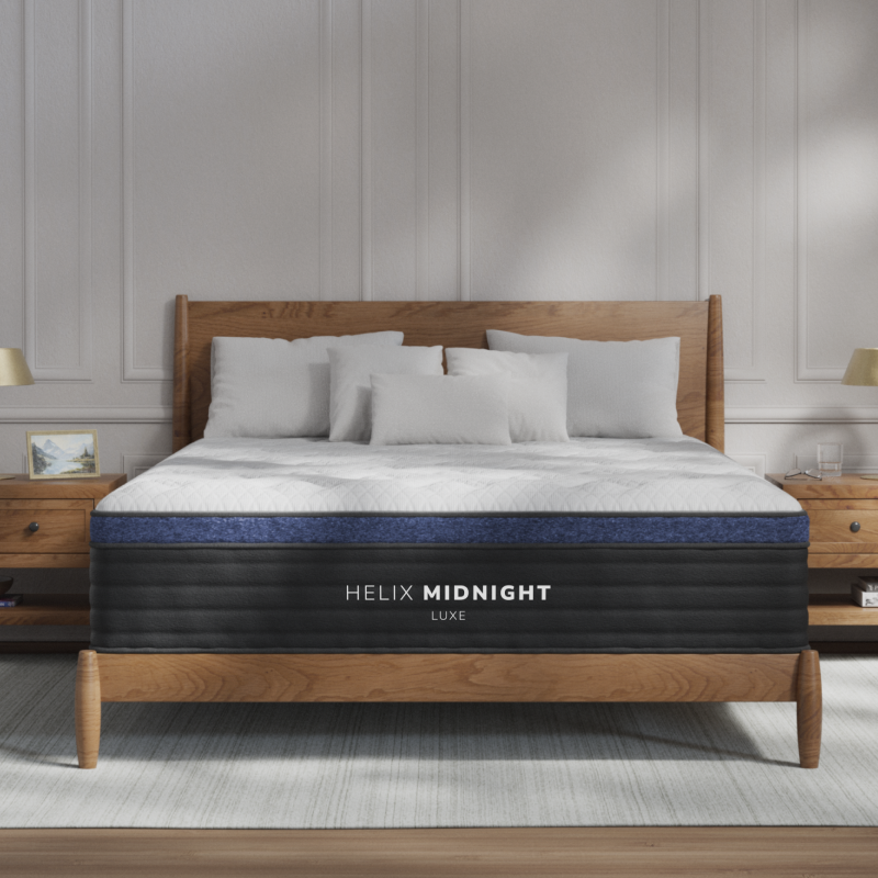 Helix Midnight Luxe hybrid mattress on a wood platform bed in a bedroom
