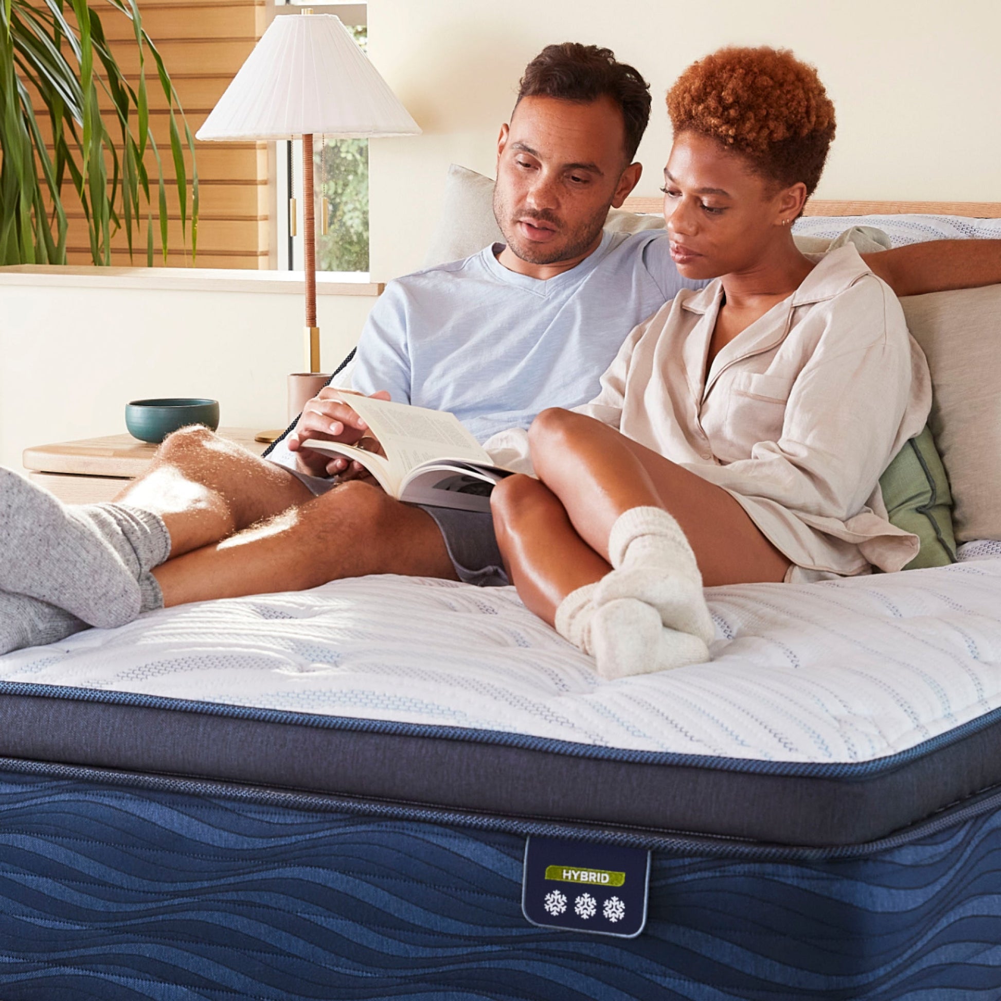 Couple Relaxing On Serta iComfortECO Quilted Hybrid Ultra Plush Pillow Top Mattress