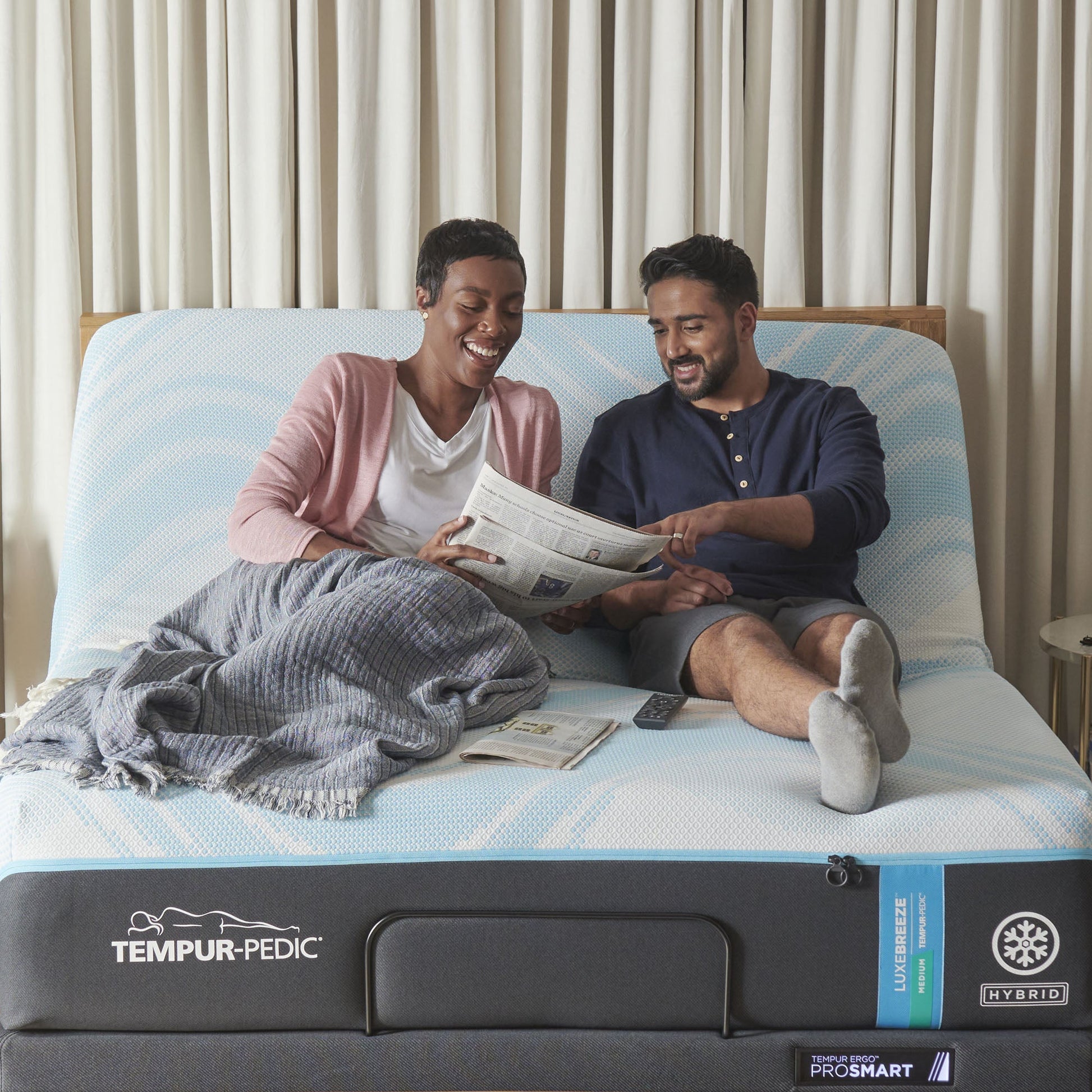 Couple relaxing on a mattress on a Tempur-Pedic Ergo ProSmart Adjustable Base