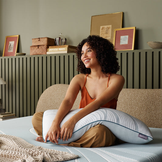 Model resting on TemperPedic Adapt Pro Adjust Pillow