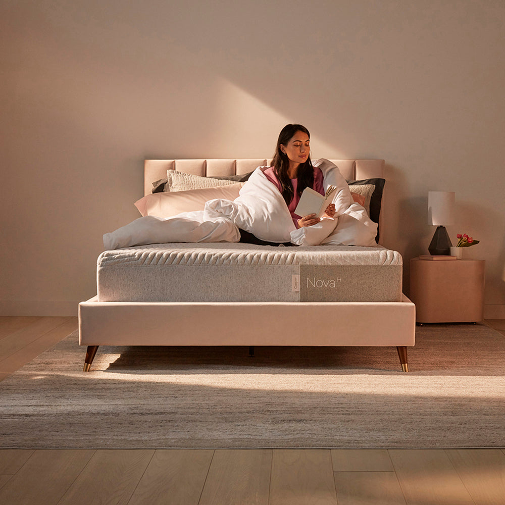 Woman Relaxing On Casper Nova Hybrid Mattress On Bed In Bedroom