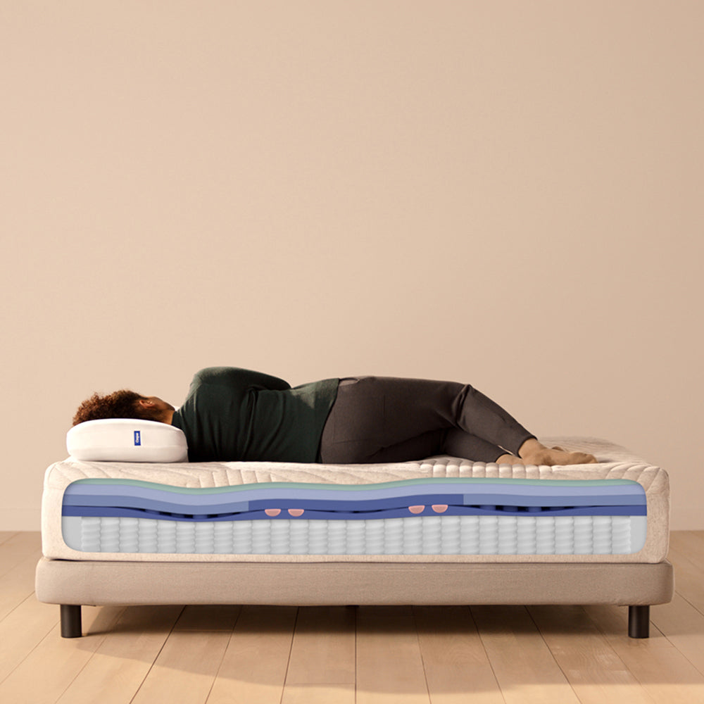 Woman Sleeping On Casper Wave Hybrid Mattress, With Mattress Showing Foam Layer Cutaway