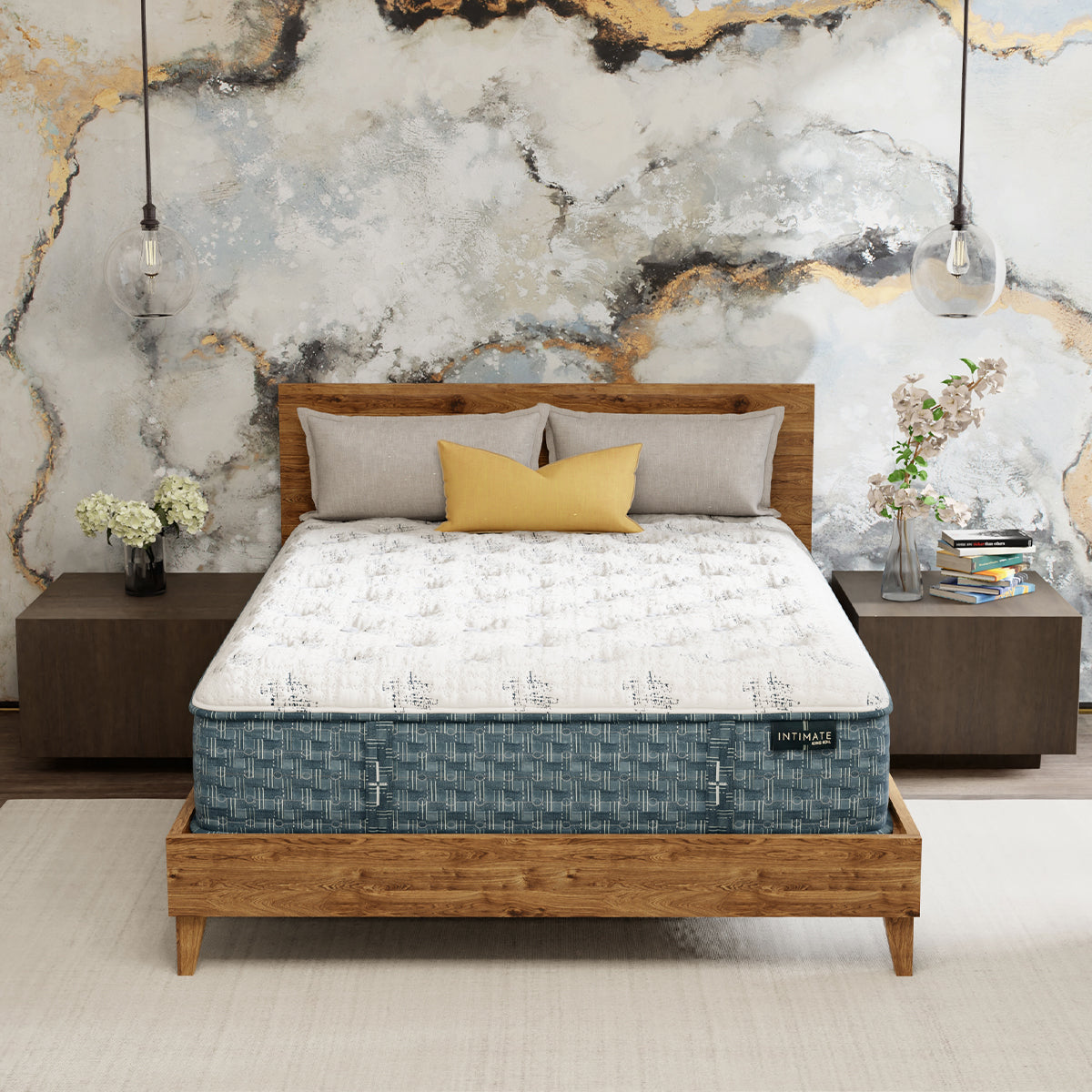 King Koil Crisfield Firm mattress on wooden platform bed in an upscale modern bedroom with wooden end tables and Edison globe lamps.