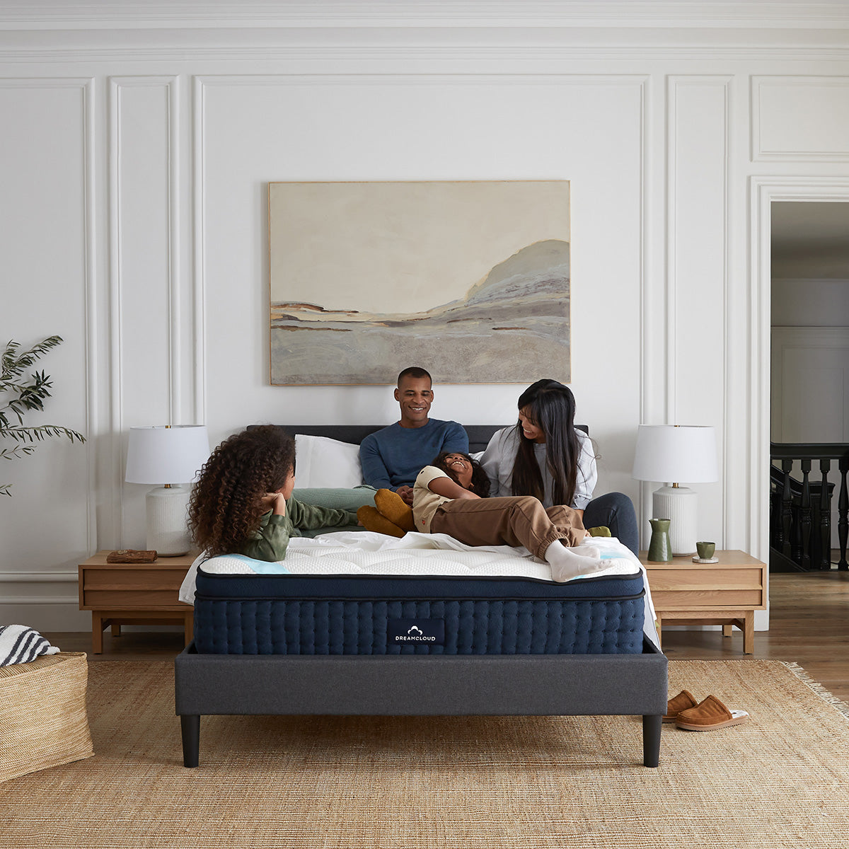 Family Laughing and Relaxing On The DreamCloud Premier Hybrid Mattress