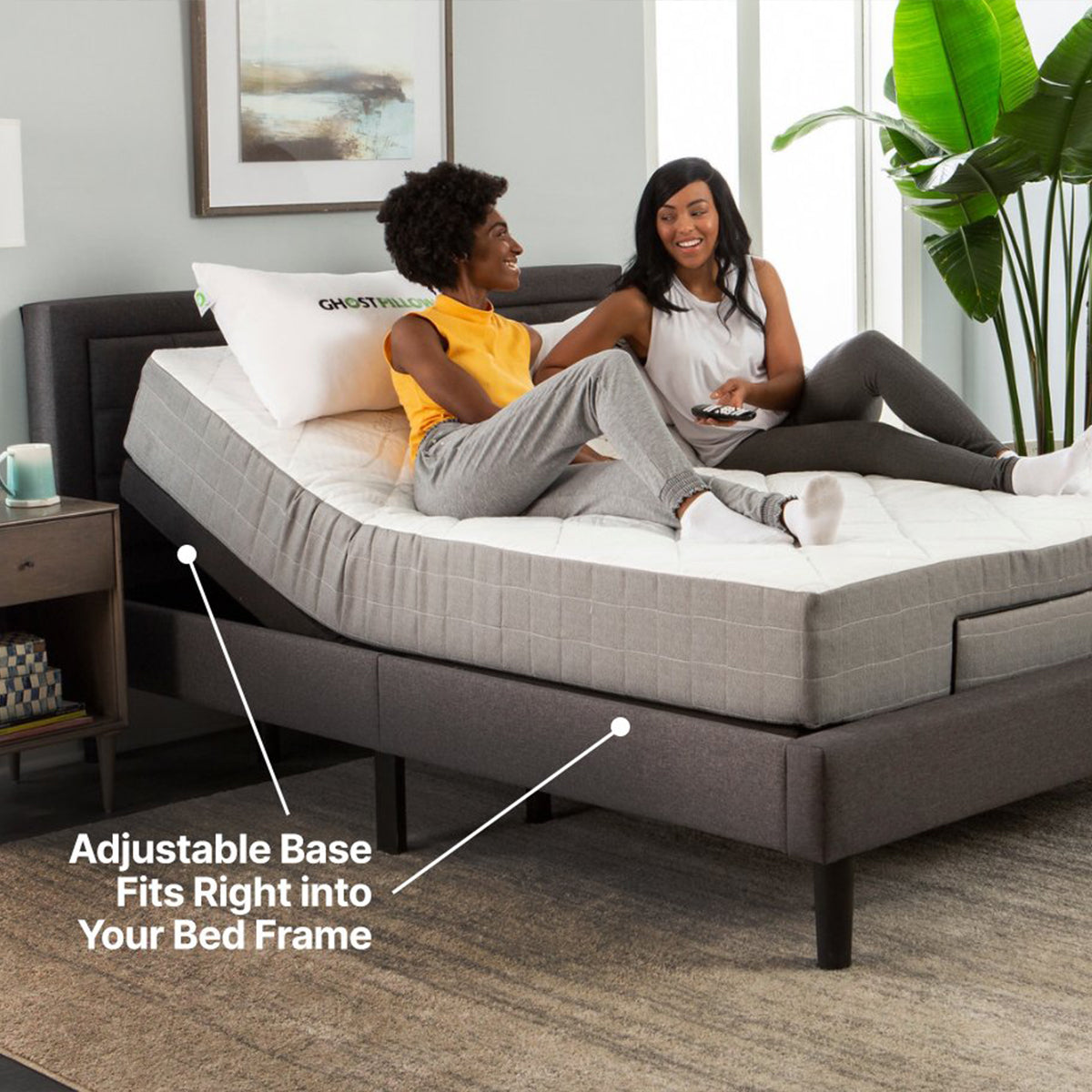 Friends Sitting on mattress elevated by a GhostBed Adjustable Base