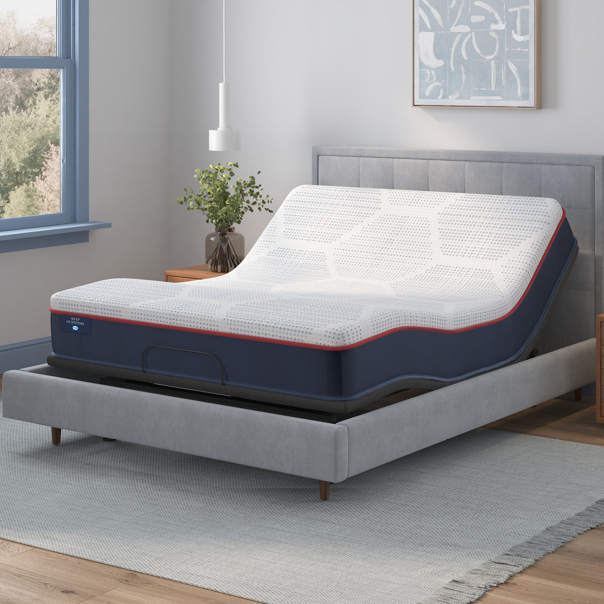 Sealy® Sleep Outfitters Apollo Firm Hybrid Mattress on an adjustable base bedroom image
