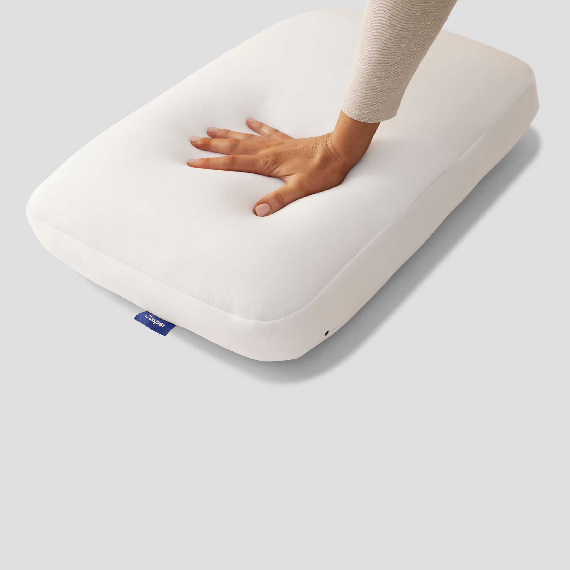 Hand Pressing On Casper Hybrid Pillow