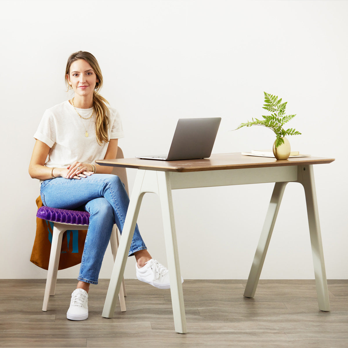 Woman Sitting On Purple Royal Seat Cushion GelFlex Grid On A Chair At Her Desk