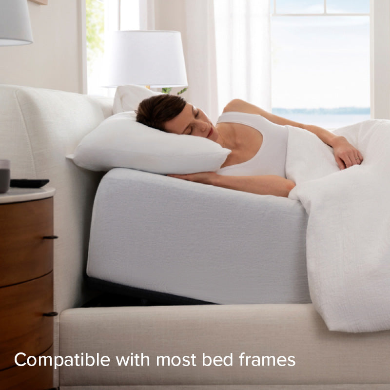 Purple Adjustable Bed Base lifestyle image  with model. Compatible with most bed frames.