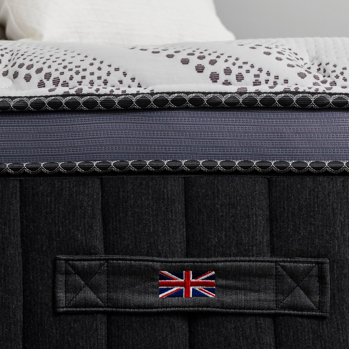 Spink & Co Warwick Euro Top mattress showing side paneling, cover fabric, and carrying handle with stitched Union Jack flag