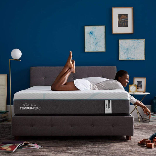 TEMPUR-Adapt Medium Hybrid Mattress Room Shot with Girl Relaxing on Bed
